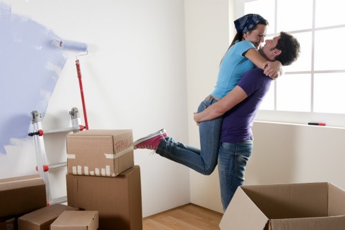 Local removals team handling furniture on a Queensbury street
